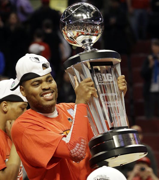 Ohio State forward Deshaun Thomas (1) holds up the Big Ten Championship trophy after an NCAA college basketball game against Wisconsin in the champion