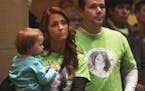 During the "Action Day" held by the Minnesota Coalition for Battered Women, Tonya Barthel held her daughter Ashlyn Watson, 1, as her boyfriend Jamie E