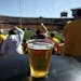 A beer sits atop a garbage can as Gopher fans cheer a long first quarter play against New Hampshire Sept. 8, 2012, at TCF Bank Stadium.