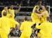 Michigan players celebrate an 87-85 win in overtime against Kansas