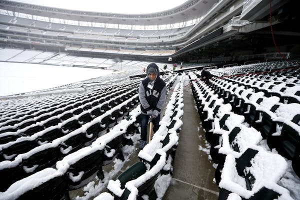 Kashaun Gage removed snow from Target Field on Thursday.