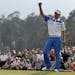 Amateur Guan Tianlang celebrates after a birdie putt on the 18th green during the first round of the Masters