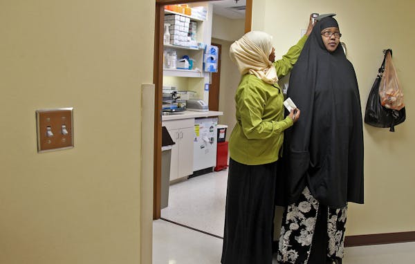 Medical assistant Abiin Mohamud helped patient Fartun Amiir before her appointment with the pharmacist and doctor at Cedar Riverside Clinic.