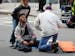 In this photo provided by The Daily Free Press and Kenshin Okubo, people assist an injured after an explosion at the 2013 Boston Marathon in Boston, M