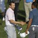 Sergio Garcia, of Spain, left, shakes hands with Tiger Woods at the conclusion of the third round of The Players championship golf tournament at TPC S