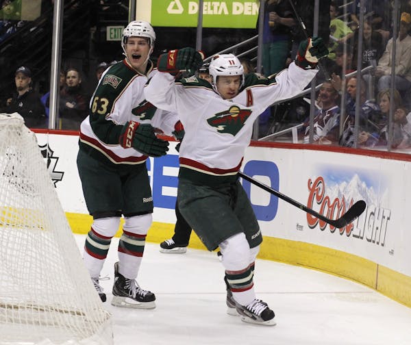 Minnesota Wild left wing Zach Parise, front, celebrates his goal with right wing Charlie Coyle against the Colorado Avalanche