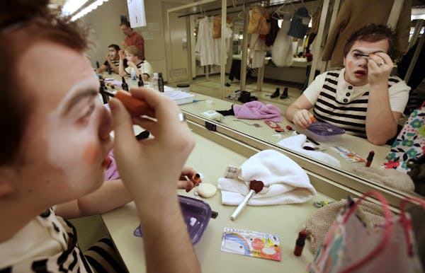 Cullen Ryan works on his makeup before rehearsal for “Alice in Wonderland.”
