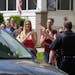Neighbors and friends of Amanda Berry clap as she arrives at her sister's home Wednesday, May 8, 2013, in Cleveland