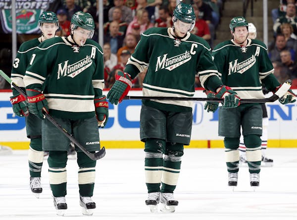 The Wild’s top line — from left, Charlie Coyle, Zach Parise and Mikko Koivu — and top defenseman, Ryan Suter, wore the look of dejection during 