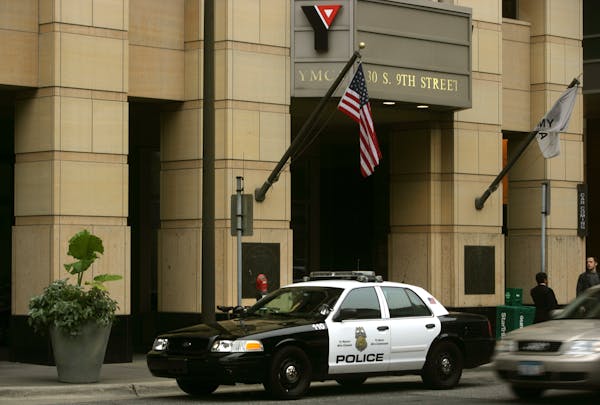In this 2010 file photo, a police car sits outside the YMCA in downtown Minneapolis after David Smith was restrained by police and later died. The dea