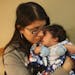 Christina Alonzo held her two-month-old son, Elijah, in the lobby of the Maple Grove Hospital Tuesday evening.