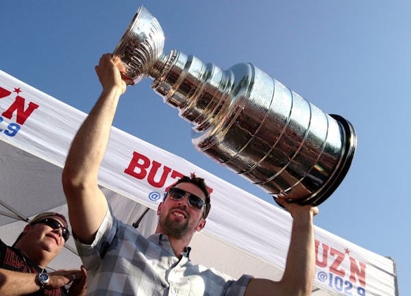 Nick Leddy hoists up the Stanley Cup at Maynard's in Excelsior Thursday.