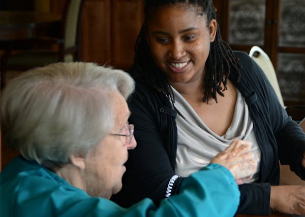 (Left to right) Virginia Bourgeois played a card game called Skip Bo with Activity Assistant Sanika Brown in Gardenview at York Gardens (Ebenezer's se
