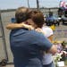 Juliann Ashcraft, of Prescott, the wife of Andrew Ashcraft, who was killed battling the Yarnell Hill Fire, hugs Andrew's father, Tom Ashcraft of Presc