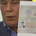In this image taken from Associated Press Television shows, Russian lawyer Anatoly Kucherena showing a temporary document to allow Edward Snowden to c
