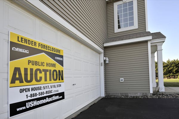 A foreclosed twinhome in Apple Valley was offered for auction in 2008. Foreclosures statewide have declined sharply since then.