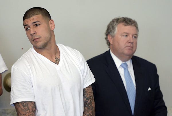 Hernandez charged with murder, cut by Patriots