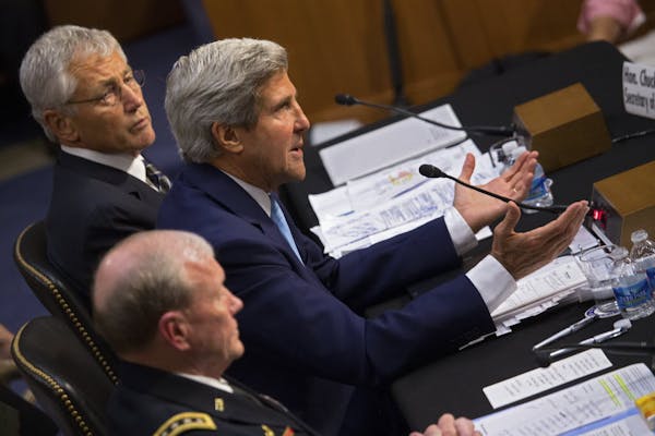 Secretary of State John Kerry is flanked by Defense Secretary Chuck Hagel and Gen. Martin Dempsey, chairman of the Joint Chiefs of Staff, as they test