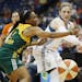 Minnesota Lynx guard Lindsay Whalen, right, passes through the defense of Seattle Storm guard Temeka Johnson (2) in the first half of a WNBA basketbal
