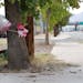 A makeshift memorial on a tree is shown, Thursday, Aug. 29, 2013, in Phoenix. An 8-year-old boy was driving his mother's car on a nighttime joyride wi