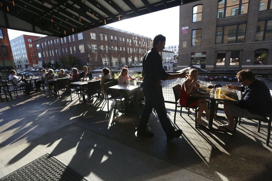 People eating on the patio at Borough restaurant, located in the North Loop, in 2013. 