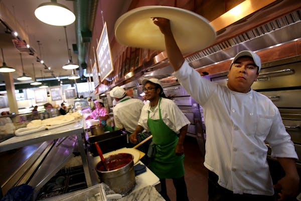 Felix Verez spins the dough for a pizza at the COUNTER at Cossettas in St. Paul.