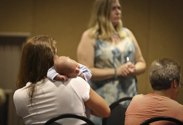 Child care provider Laurie Cornelious held her 7-month-old grandson, Gavin, at a meeting on fighting efforts to unionize home child-care workers.