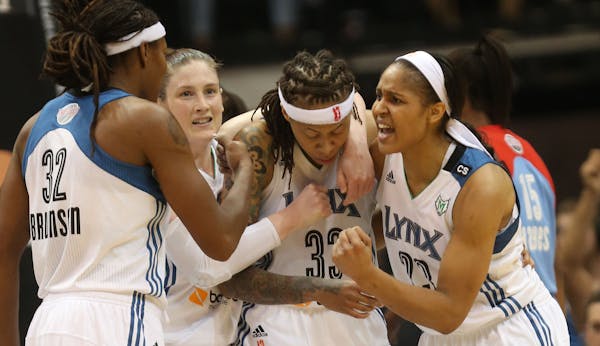 Seimone Augustus, third from left, was surrounded by Lynx teammates — from left, Rebekkah Brunson, Lindsay Whalen and Maya Moore — after scoring a
