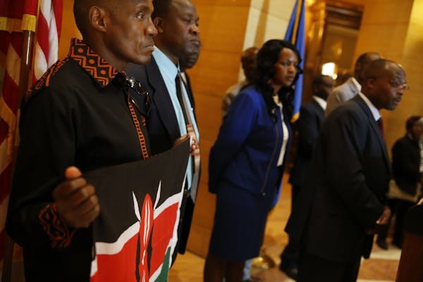 In the rotunda of the state capitol in St. Paul, Kihanya Mwaura held the Kenyan flag in solidarity with other Minnesotan Kenyans who were taking a sta