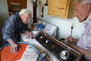 At her home in Pottsdam, Anna Stoehr talks to her son Harlan,83 who is changing the hoses on her washer. She is perhaps the oldest person who lives al