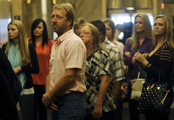 In this Sept. 19 file photo, Kira Steger's parents Jay Steger and Marcie Steger, center left and right, wait for an elevator before heading to the cou
