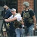 Law enforcement personnel respond to an attack on office workers at Washington Navy Yard Monday morning, September 16, 2013. A gunmen opened fire and 
