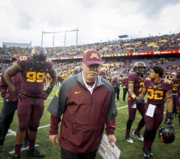 Jerry Kill, head coach for the University of Minnesota football team, walks off the field after a home game against the Iowa Hawkeyes in Minneapolis, 