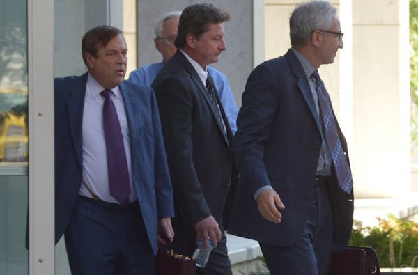 James Fry (carrying water bottle) left the federal courthouse in St. Paul on Wednesday after being sentenced for his role in the Tom Petters fraud cas