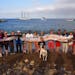 The crew of sailing school vessel Tole Mour and Catalina Island Marine Institute instructors hold an 18-foot-long oarfish that was found in the waters