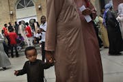 Abdullahi Hassan, 18 months, waited with his father, Bashir Farah, after a Friday afternoon prayer service at the Islamic Center of St. Cloud.