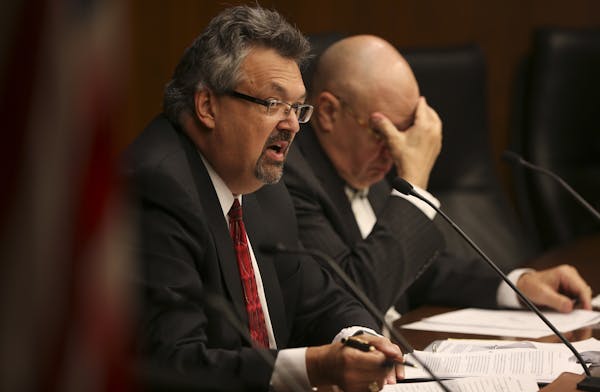 Retired Minnesota Supreme Court Justice Eric Magnuson, left, chair of the Sex Offender Civil Commitment Advisory Task Force, guided the discussion of 