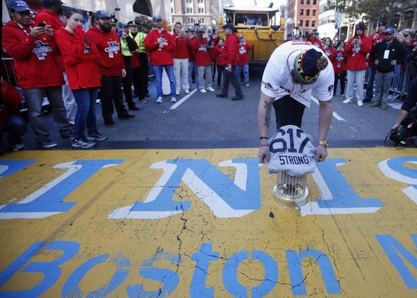 Red Sox place World Series trophy on marathon finish line