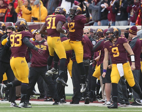 Gophers players celebrated late in the fourth quarter en route to defeating Nebraska at TCF Bank Stadium. Minnesota won, 34-23.