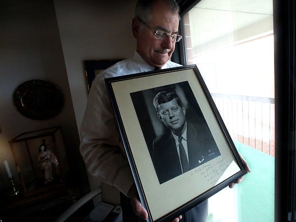 Hennepin County Attorney Mike Freeman with a portrait that JFK gave to his father, Orville Freeman.