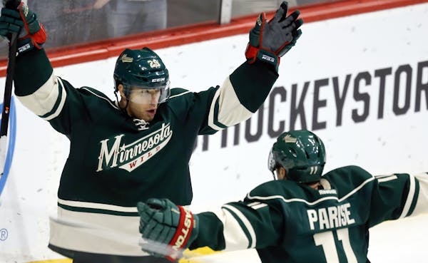After scoring the game winner, Minnesota Wild's Jason Pominville (29) is greeted by teammate Zach Parise (11) during third period action Montreal.