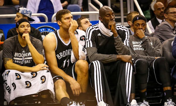 Brooklyn Nets players Deron Williams (8), Brook Lopez (11), Kevin Garnett (2), and Paul Pierce (34) react as the are defeated by the Orlando Magic, 10