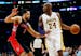 Los Angeles Lakers' Kobe Bryant dribbles the ball as he is guarded by Toronto Raptors' Landry Fields, left, during the first quarter of an NBA basketb