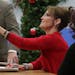 Sarah Palin shakes the hand of a woman as she signs copies of her book, "Good Tidings and Great Joy: Protecting the Heart of Christmas," at Walmart in