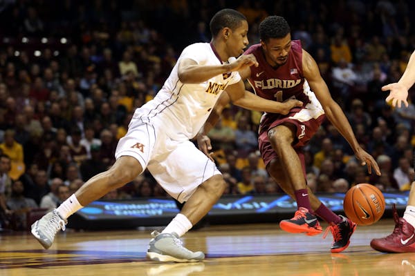 Gophers DeAndre Mathieu attempted to steal the ball from Florida State's Devon Bookert during the first half at Williams Arena in Minneapolis, Tuesday