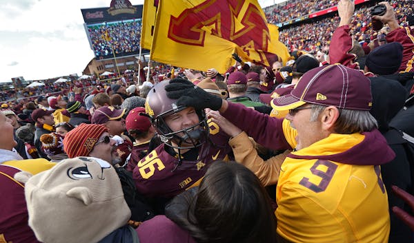 Dave Ramlet was mobbed by fans after the Gophers’ 34-23 victory over Nebraska on Oct. 27 at TCF Bank Stadium.