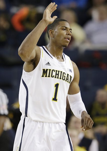 Michigan forward Glenn Robinson III (1) reacts after a play during the first half of an NCAA college basketball game against Houston Baptist in Ann Ar