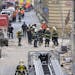Firefighters and rescue workers work at the scene of a strong blast in a building in the center of Prague, Czech Republic, in the morning on Monday, A