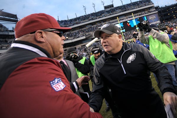 Philadelphia Eagles head coach Chip Kelly, right, meets with Arizona Cardinals head coach Bruce Arians after an NFL football game, Sunday, Dec. 1, 201