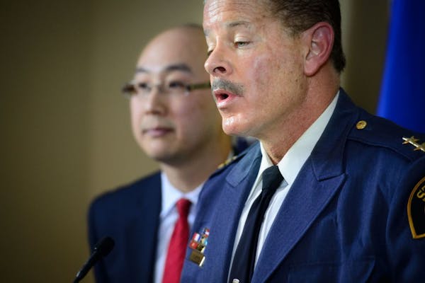 St. Paul Police Chief Tom Smith, foreground, and Ramsey County Attorney John Choi spoke during a news conference Wednesday announcing that there would